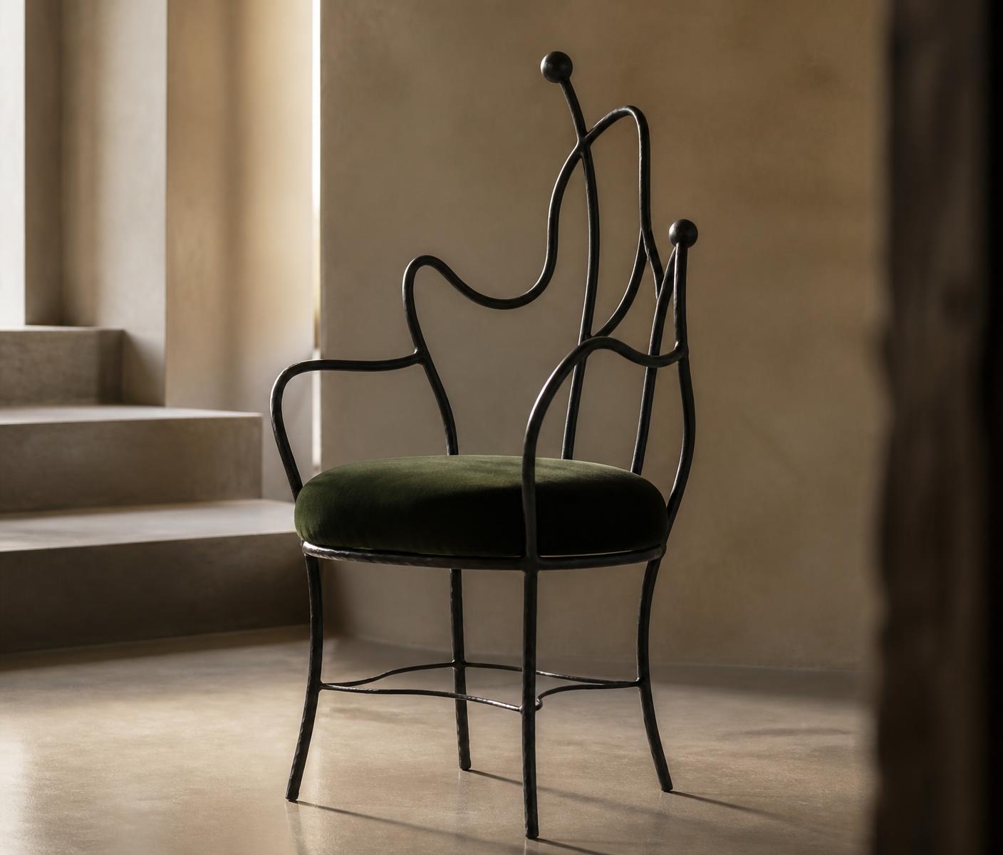 Sculptural hand-forged metal chair with green velvet seat
